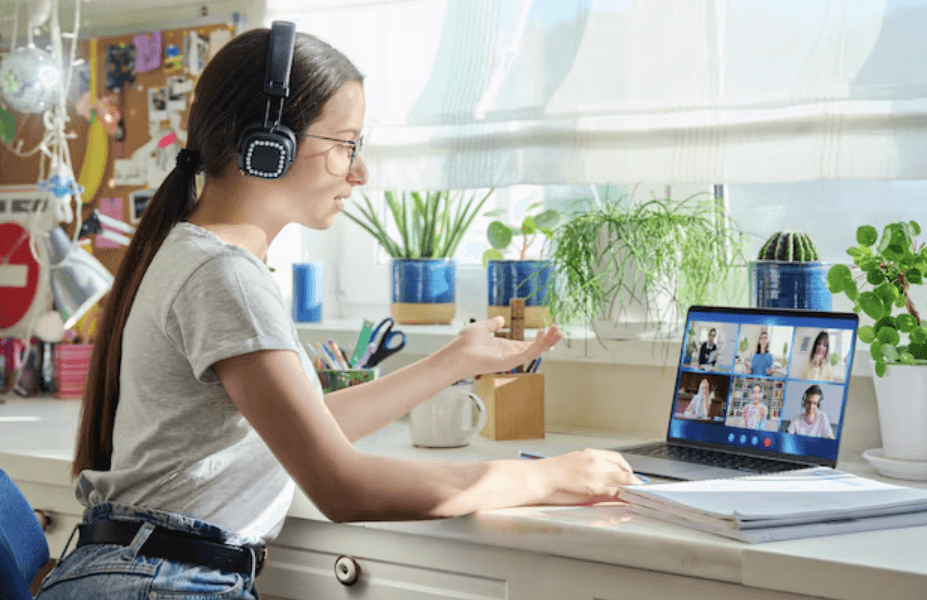 A person wearing headphones and speaking during a laptop video call.