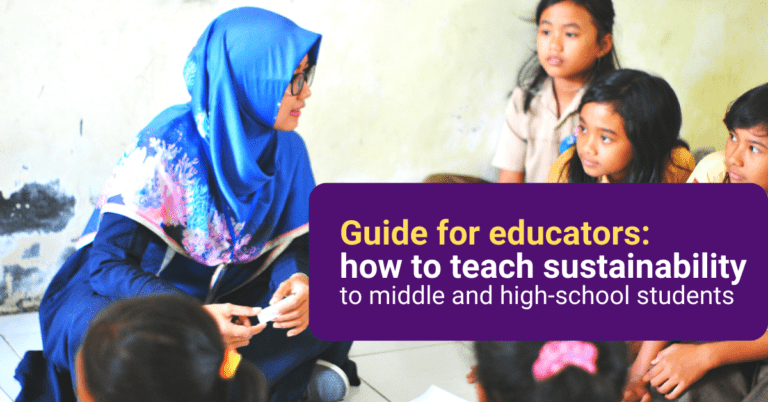 Eastern-world teacher with students talking while being sit on the floor