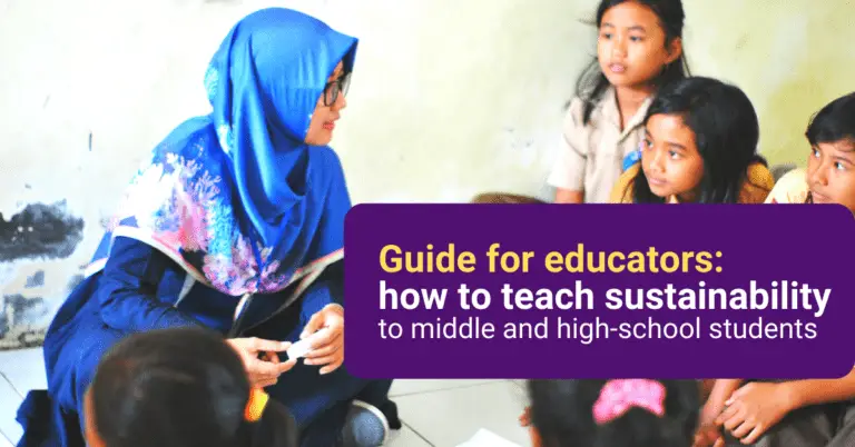 Eastern-world teacher with students talking while being sit on the floor