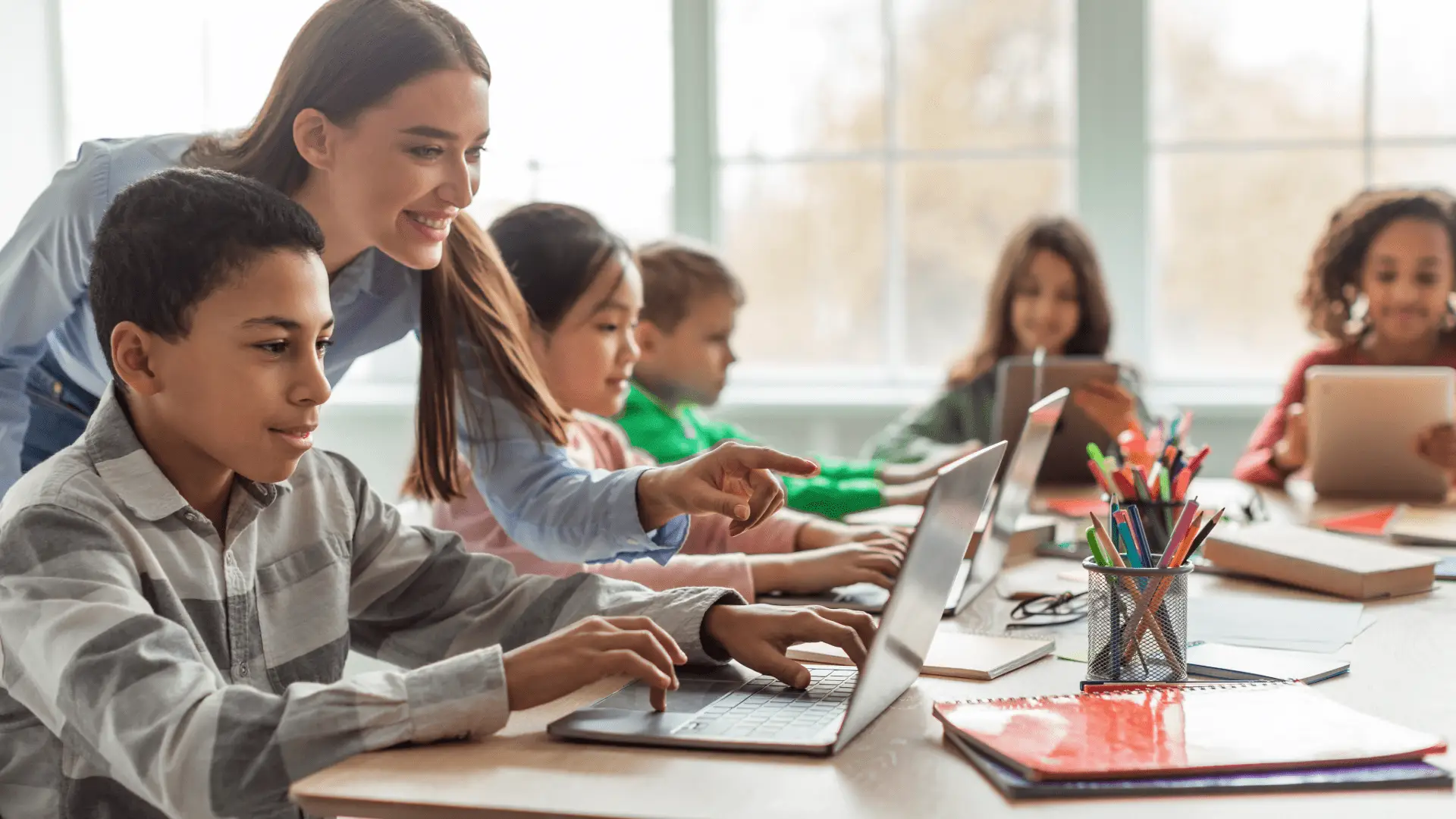 Class2Class training: Students using laptops with teacher instruction in a classroom setting