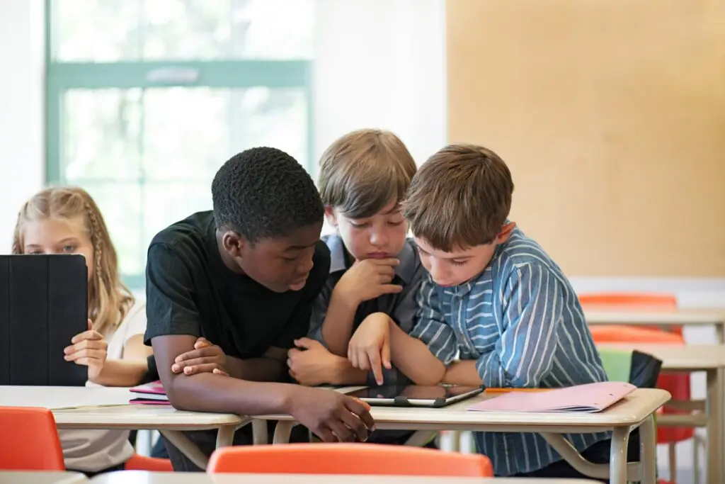 Education for sustainable development in action — diverse students collaborating on a group project in a modern classroom