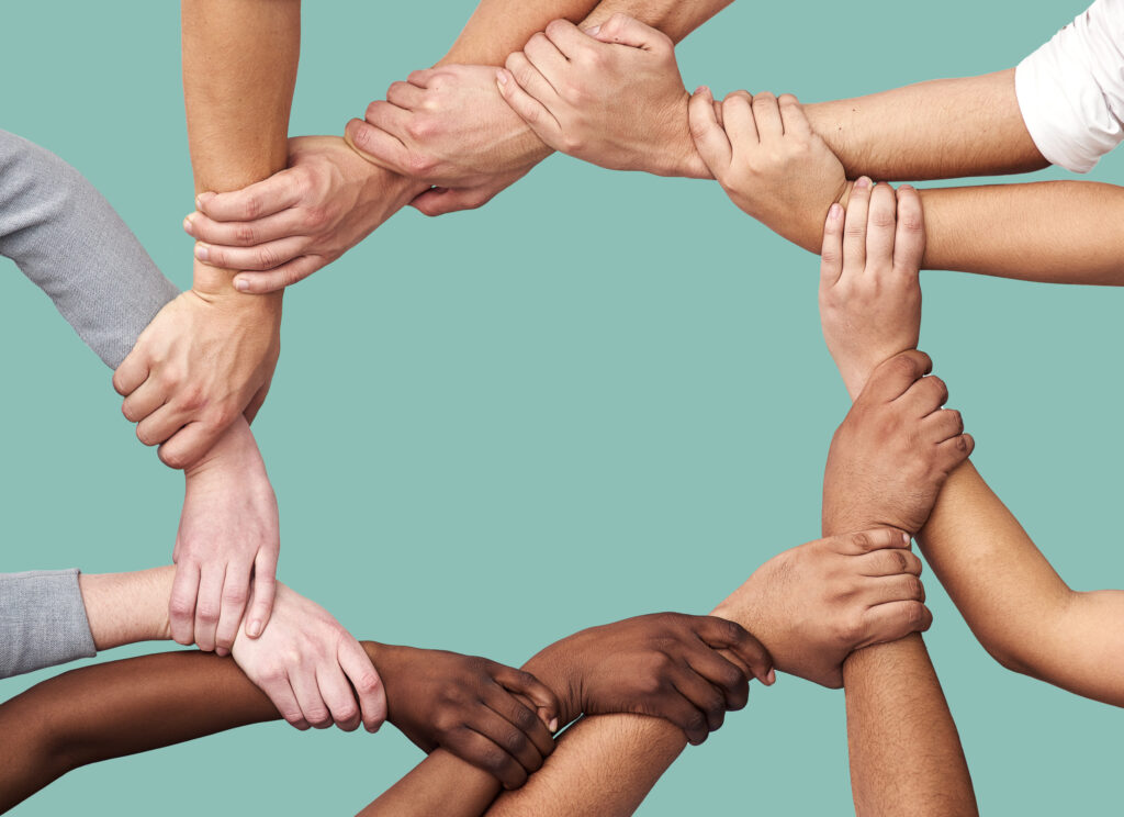 People diversity hands together teamwork collaboration trust against studio background diverse group holding hand unity solidarity community agreement circle mockup